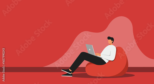 Modern man working on laptop from a comfortable bean bag, highlighting remote work flexibility and cozy home office productivity.