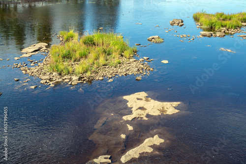 Fototapeta river flowing through rocky shallows in Oulu, Finland