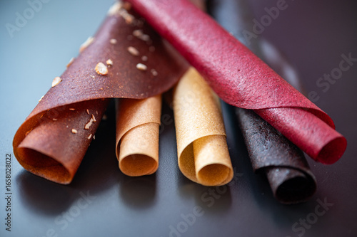 Fruit leather rolls on the table. Natural sweets from fruits.