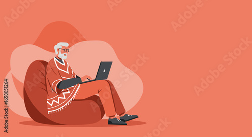 Senior man comfortably works on his laptop from a bean bag chair. Represents modern retirement, digital literacy, and remote connectivity.