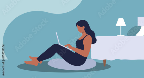 Woman working on laptop at home, sitting comfortably on floor with bed nearby. Remote work, online learning, or digital leisure concept.