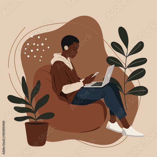 African American person working remotely on laptop and phone from a cozy beanbag, showcasing modern flexible lifestyle.