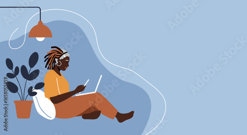 An African American woman comfortably works or studies from home using a laptop and phone. Ideal for themes of remote work, technology, and modern lifestyle.