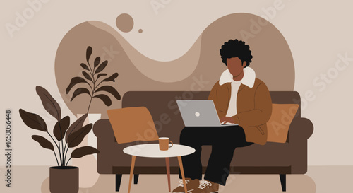 Young man working remotely on his laptop from a comfortable sofa, representing flexible home office, productivity, and a relaxed digital lifestyle.