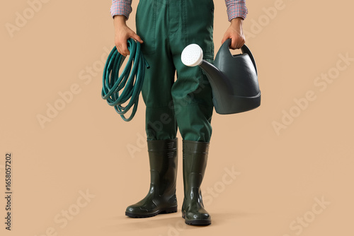 Male gardener with watering...