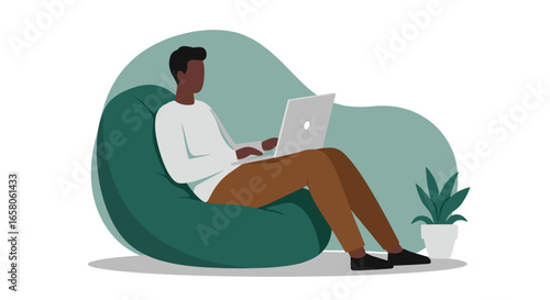 Young man working remotely on a laptop, comfortably seated on a beanbag chair at home. Ideal for telecommuting, freelance, and online learning concepts.