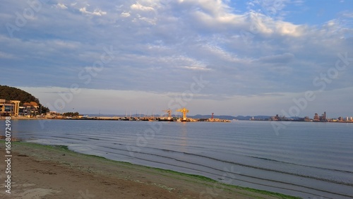 Wallpaper Mural coastal beach with harbor cranes and city skyline in the distance Torontodigital.ca