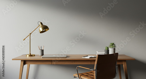 A modern home office setup with a wooden desk, gold lamp, and leather chair against a plain wall.