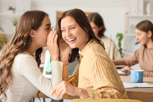 Female students gossiping a...