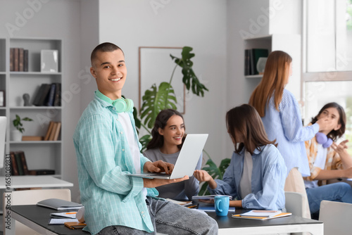 Male student studying with ...