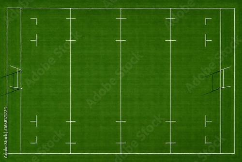 Aerial view of a green rugby field, meticulously marked with crisp, white boundary and goal lines.