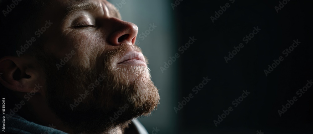 Obraz premium Caucasian man with closed eyes in contemplation indoors Concept of mindfulness, meditation, and relaxation