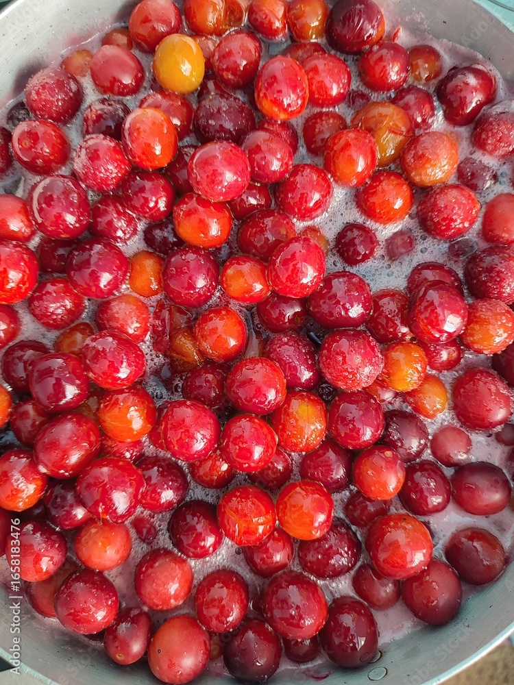 Prunus cerasifera, also known as cherry plums, are simmering gently in a pot, transforming into a flavorful jam. Steam rises as the fruits soften, promising a delicious homemade preserve Prunus cerasifera, also known as cherry plums, are simmering gently in a pot, transforming into a flavorful jam. Steam rises as the fruits soften, promising a delicious homemade preserve