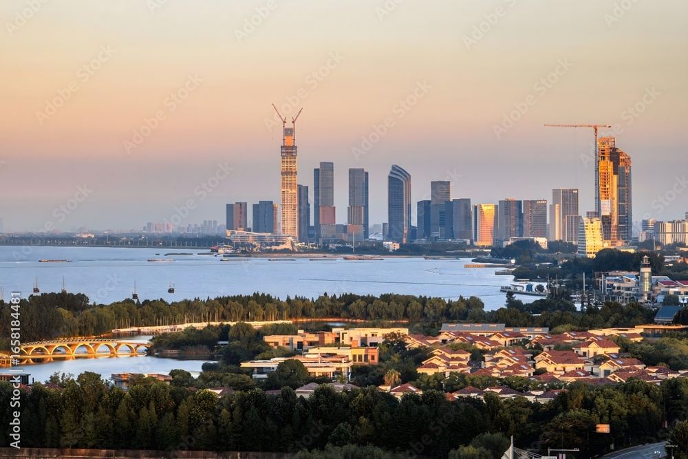 Obraz premium Aerial View of Huzhou City Skyline at Sunset, Modern Urban Landscape with Lake and Skyscrapers, Zhejiang Province China