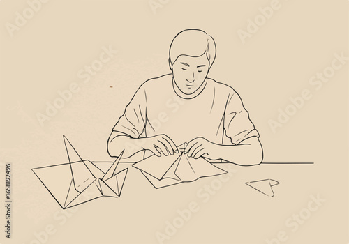 Man folding paper at a table, with finished origami figures as background