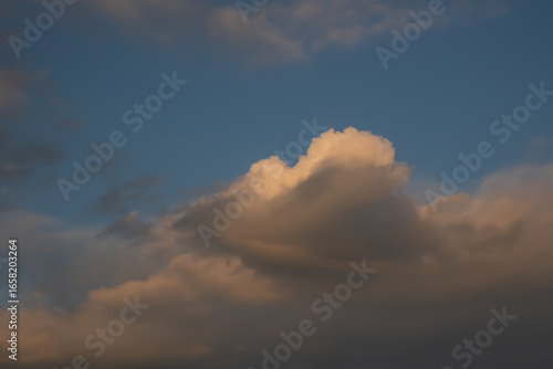 White Fluffy Clouds with a Sunset Hue in a Blue Sky