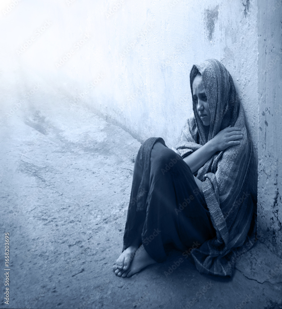 Naklejka premium Frozen girl sitting on the floor