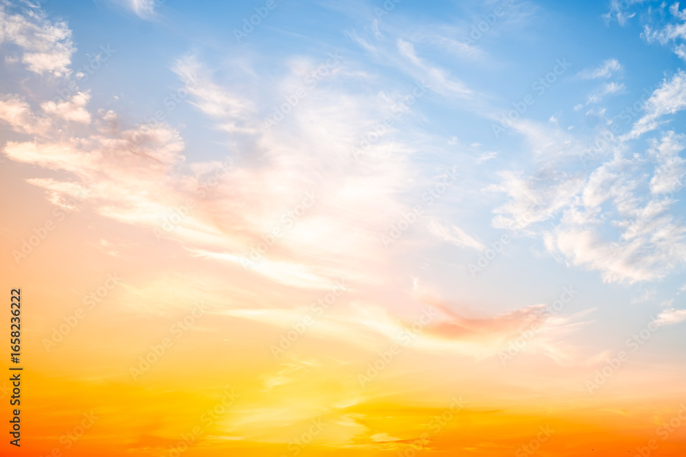 Obraz premium Beautiful , luxury soft gradient orange gold clouds and sunlight on the blue sky perfect for the background, take in evening,Twilight, Large size, high definition landscape photo