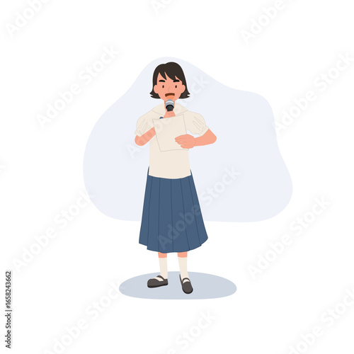 asian elementary schoolgirl in thai uniform holding microphone and paper presenting confident student speech in classroom