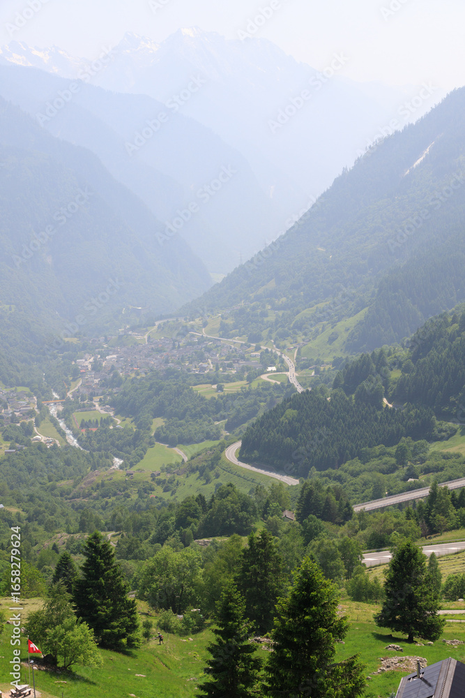 Fototapeta premium Picturesque alpine landscape with green valley and mountain forest in Switzerland