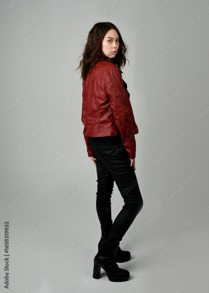 Brunette Woman in Red Leather Jacket Full Length Studio Portrait Isolated on White Background Backwards Facing Silhouette Modern Dystopian Fashion Brunette Woman in Red Leather Jacket Full Length Studio Portrait Isolated on White Background Backwards Facing Silhouette Modern Dystopian Fashion
