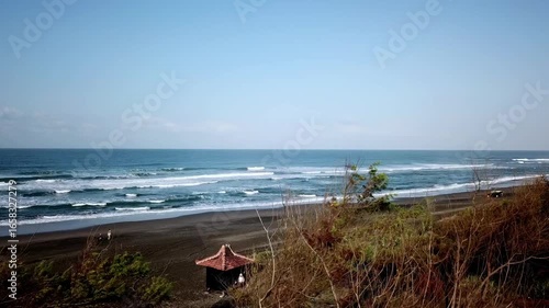 Aerial view of Parangtritis Beach in Bantul, Yogyakarta, Indonesia. Scenic coastline with rolling waves, golden sand, and tropical landscape, perfect for travel and tourism concepts.