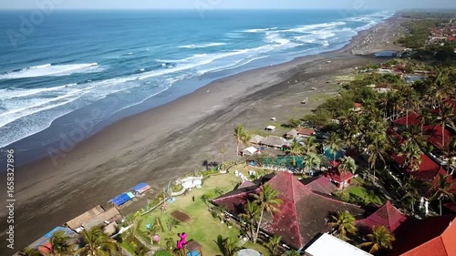 Aerial view of Parangtritis Beach in Bantul, Yogyakarta, Indonesia. Scenic coastline with rolling waves, golden sand, and tropical landscape, perfect for travel and tourism concepts.