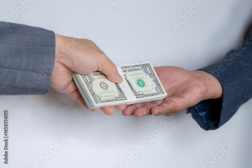 Close-up symbolic shot of corruption and bribery, showing hidden hand receiving money envelope under the table
