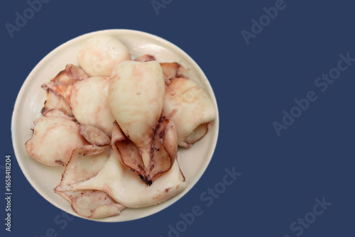 isolated top view boiled whole squid carcasses on a plate