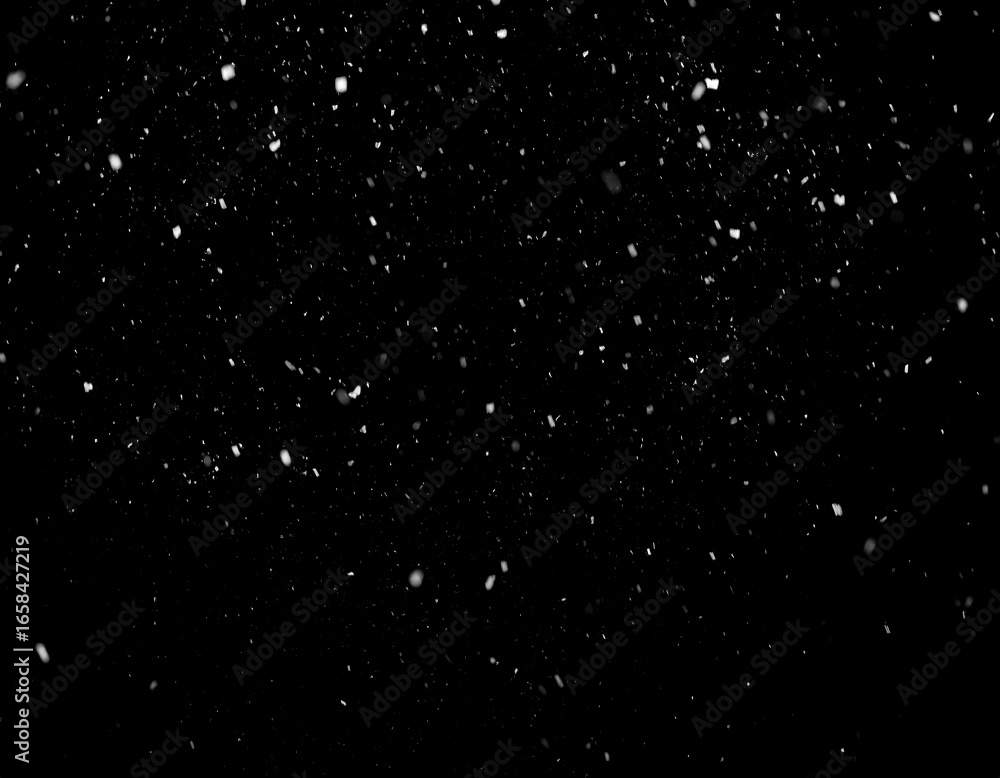 Fototapeta premium Snowflakes falling on a black background