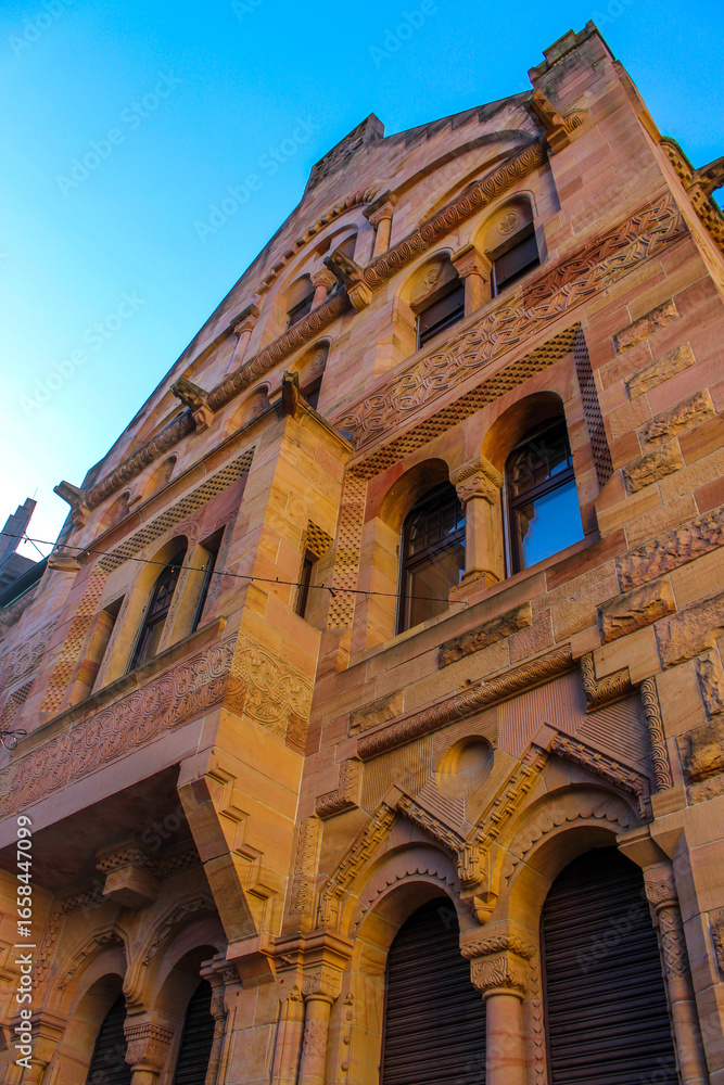Obraz premium large stone late medieval building with a facade in a pleasant brown is illuminated by the sun