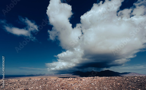 Moody Volcanic Landscape in Lanzarote with Deep Blue Sky and Cloud Shadows