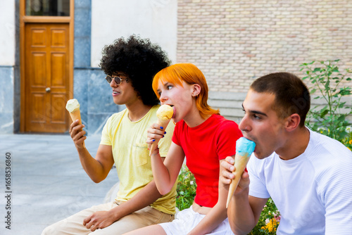 Three friends enjoying ice cream cones outdoors