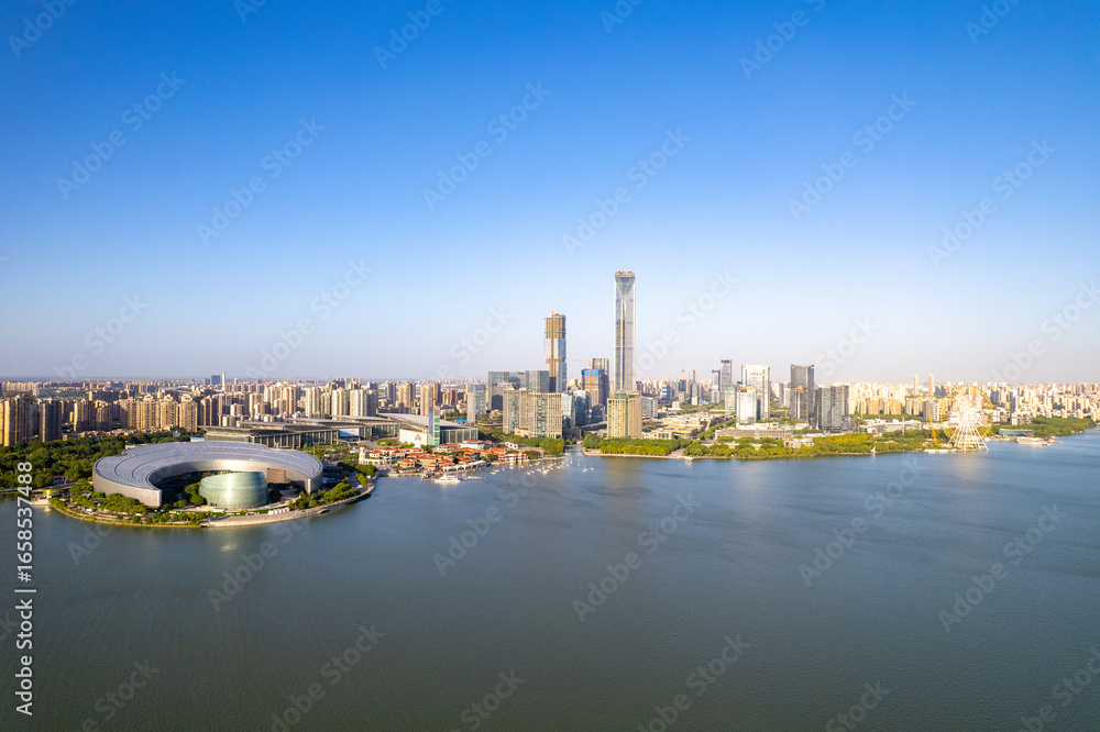 Naklejka premium Modern city skyline with lake and buildings in Suzhou, China