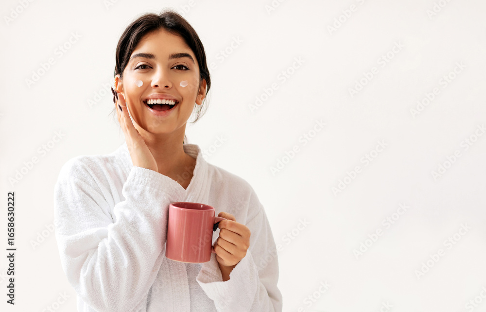 Happy Lady With Cream Dots On Face Posing Holding Coffee Cup Standing In Modern Bathroom Indoor, Wearing Bathrobe. Beauty Morning, Facial Skincare Routine Concept Happy Lady With Cream Dots On Face Posing Holding Coffee Cup Standing In Modern Bathroom Indoor, Wearing Bathrobe. Beauty Morning, Facial Skincare Routine Concept