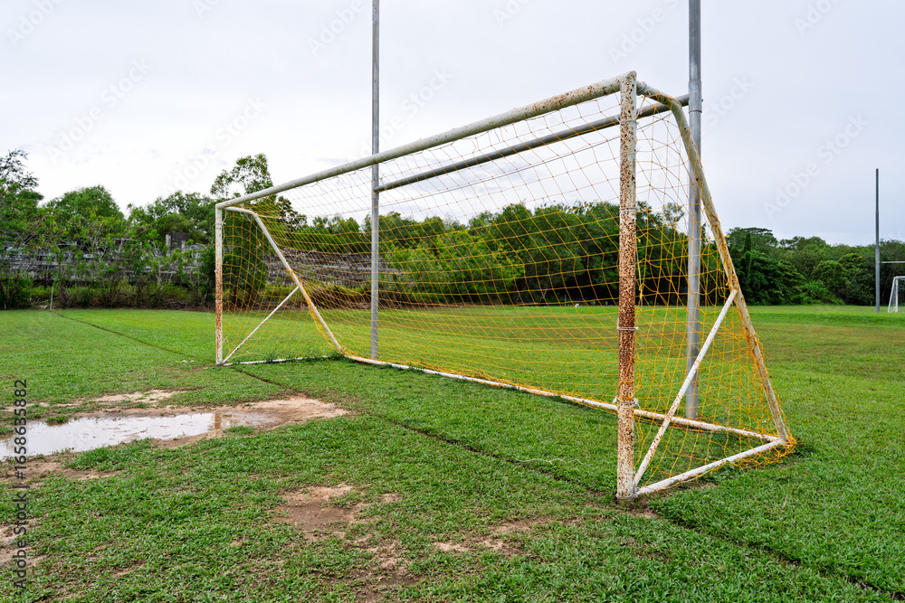 Rusty Soccer Goal Post on Wet Field Rusty Soccer Goal Post on Wet Field