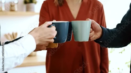 Three people holding mugs and enjoying a casual conversation in a cozy home kitchen, sharing a moment of relaxation and connection over warm beverages 4k video