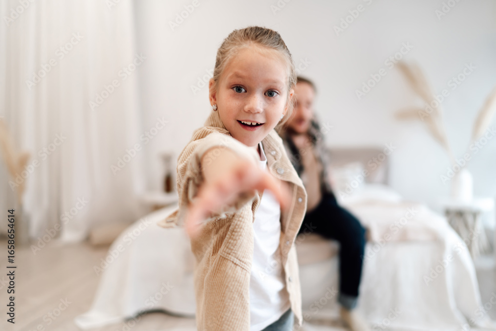 Fototapeta premium Father and daughter hold each other closely while smiling, gazing eye to eye on bed, reflecting strong emotional presence in modern family relationships.