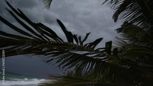 An impending hurricane approaches a deserted beach with large waves dark storm clouds these empty beach chairs are a symbol of warning and imminent danger