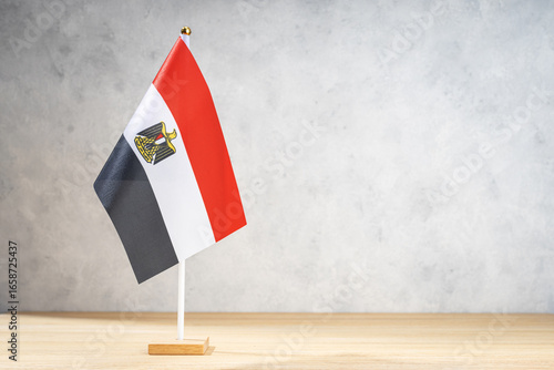 Egypt table flag on white textured wall. Copy space for text, designs or drawings