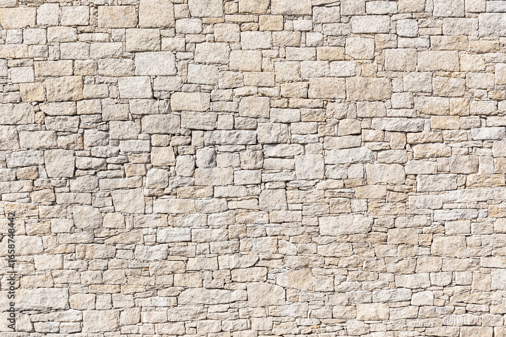 Obraz premium Granite Stone wall background texture. Dry masonry wall
