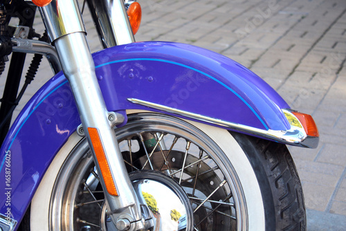 Εκτύπωση καμβά Close-up of classic motorcycle front wheel with chrome spokes, whitewall tire, and shiny purple fender accented by chrome trim
