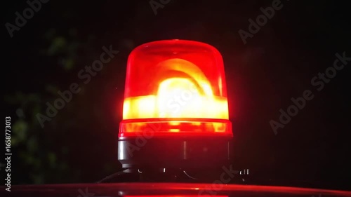 Glowing red emergency light with dark background