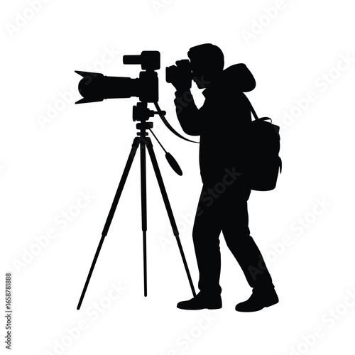 Silhouette of a professional videographer with a large camera on a tripod capturing footage