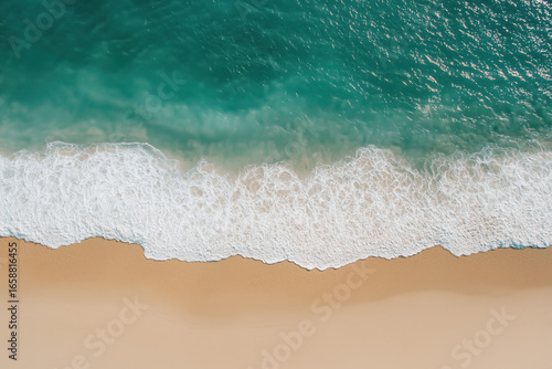Fototapeta Naklejka Na Ścianę i Meble -  Top view of beach waves hitting shoreline