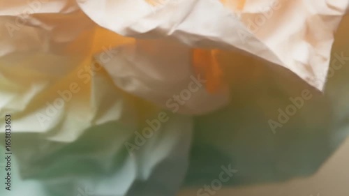 Soft Light Drifting Over Crumpled, Pastel-Colored Paper
