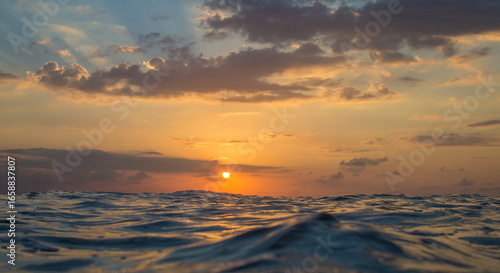 Sunset in the oceSurfing culture Sunset at ocean in Bali