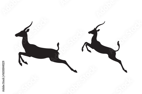 Two black silhouettes of antelopes leaping gracefully