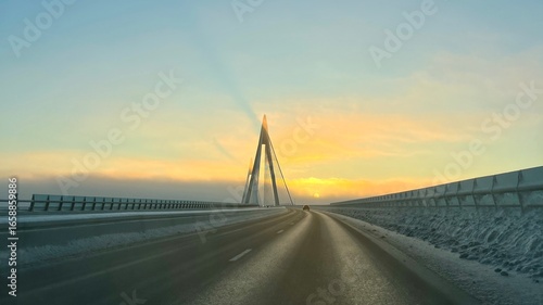 Tableau sur toile A breathtaking view of the iconic Uddevalla Bridge (Uddevallabron) enveloped in a crisp, icy winter morning glow