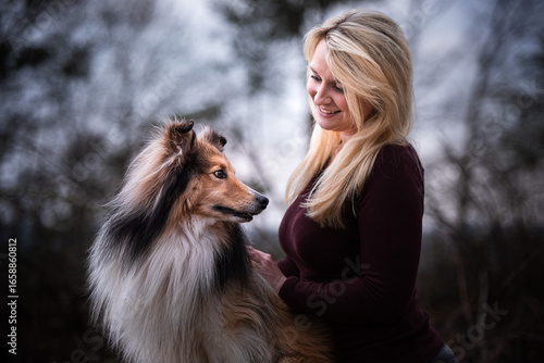 Woman with Sheltie, blue hour, cinematic purple-blue grading